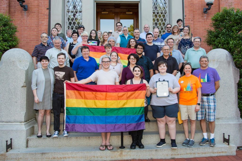Group of Frederick Center members holding pride flags