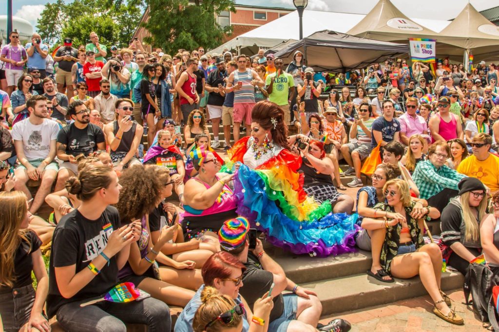 drag queen in rainbow dress interacting with audience along carroll creek