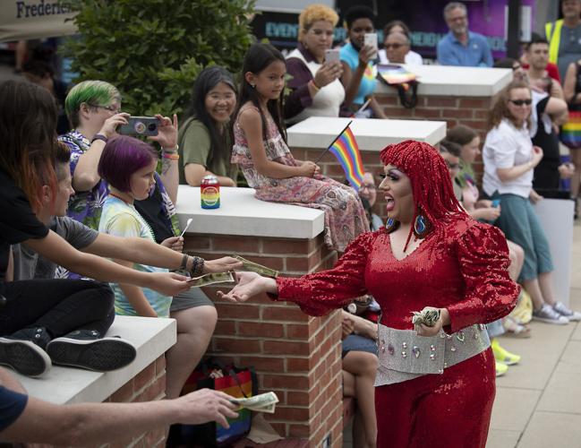 drag queen in red interacting with audience along carroll creek